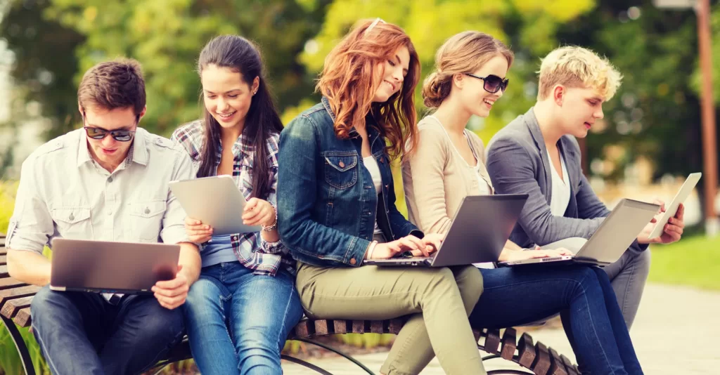 students or teenagers with laptop and tablet computers