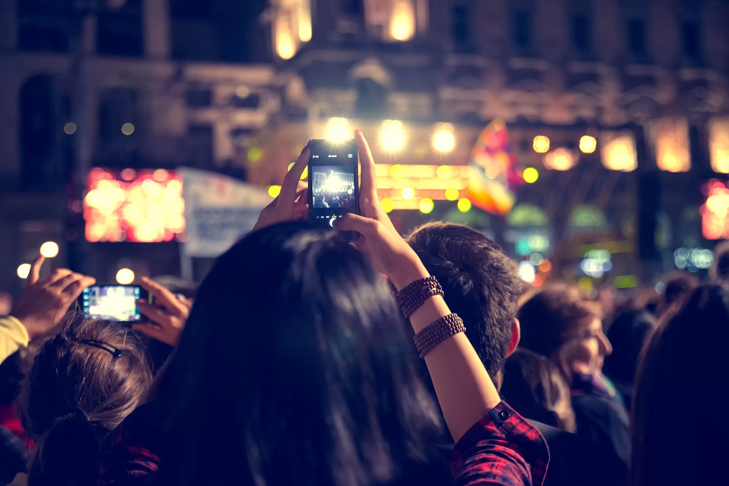 woman videoing with her phone