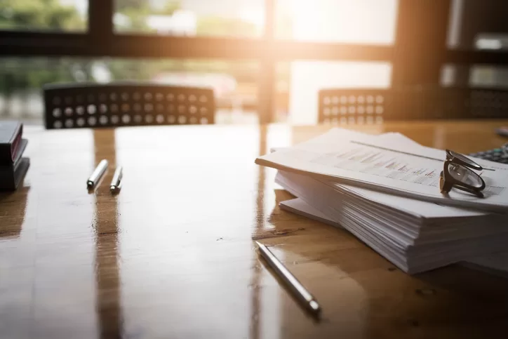 Papers on a office desk during a sunrise