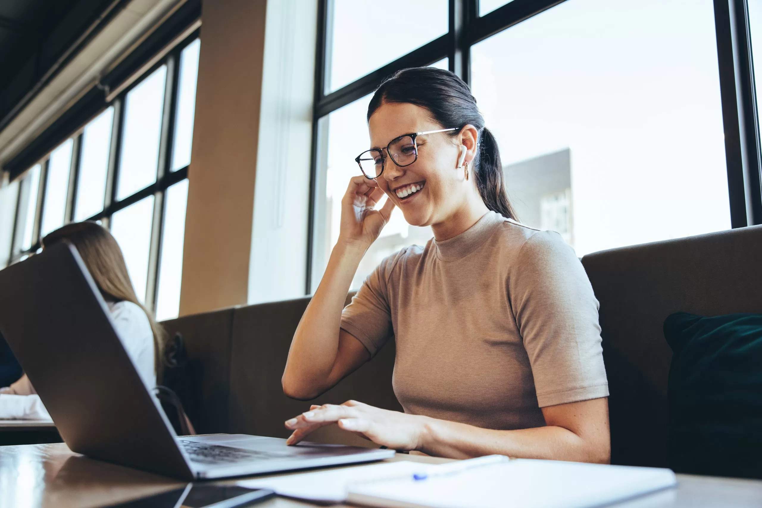 Happy businesswoman taking a video call in a co-working space