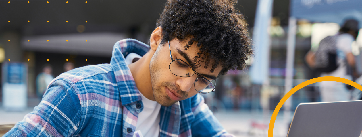 A student working at a laptop.