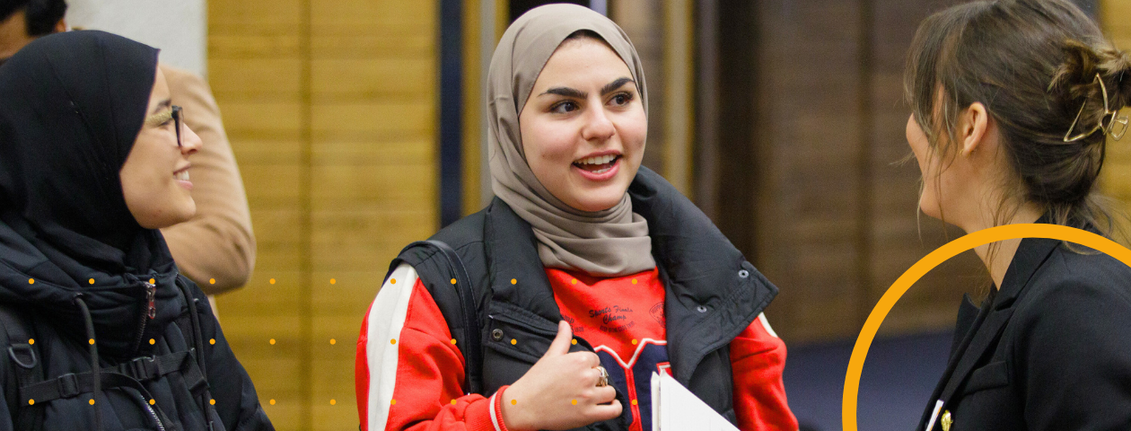 Three students at a student recruitment fair.